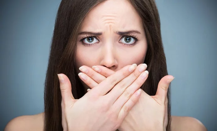 woman covering mouth