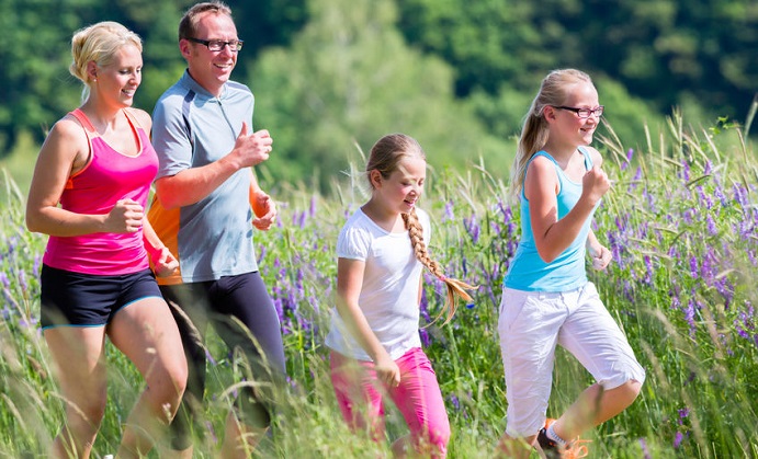 family running for better fitness in summer through beautiful landscape